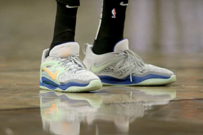 View of Kevin Durant's grey and green Nike shoes.